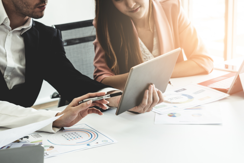 Three people sorting out an issue on an iPad.